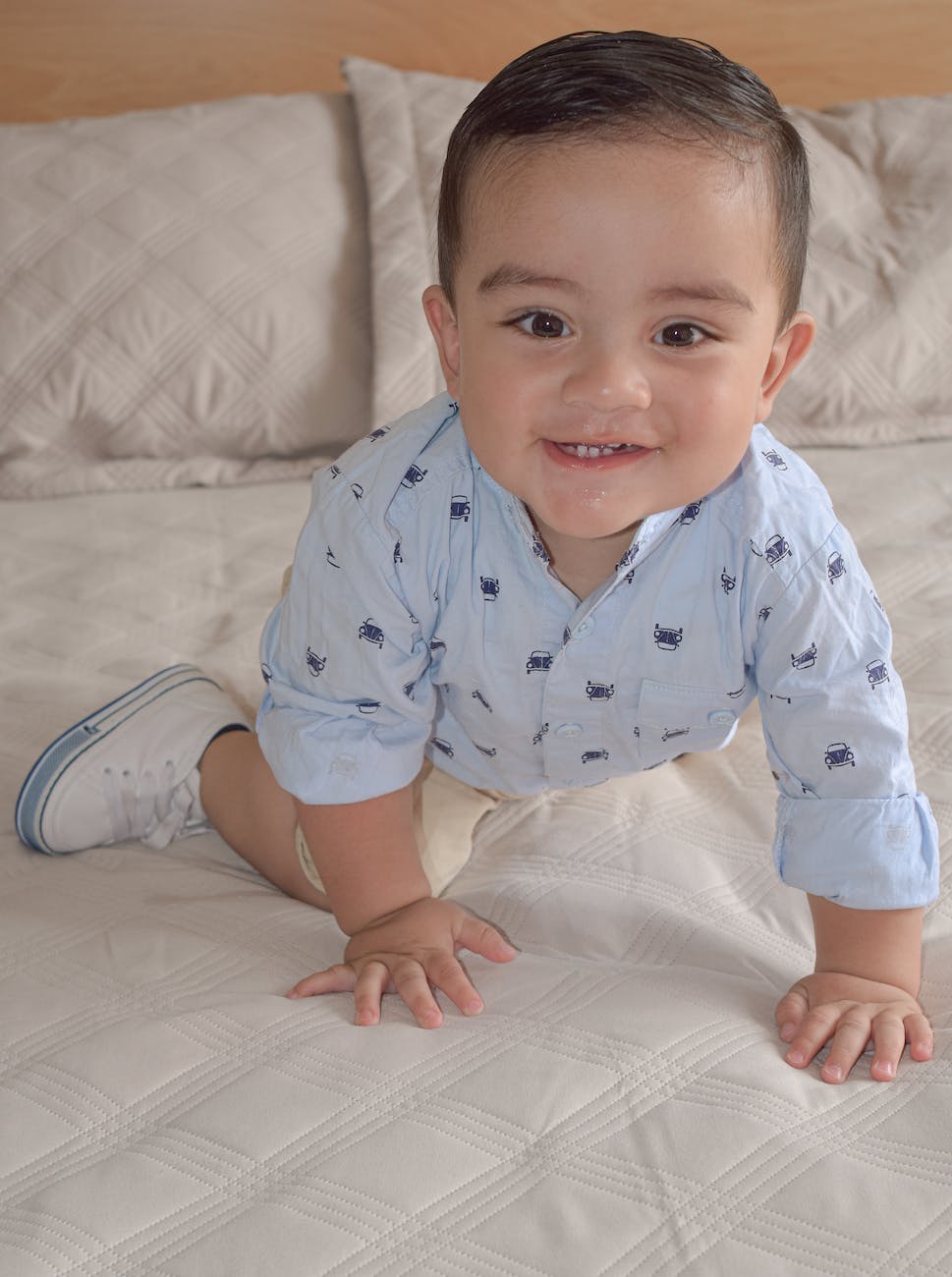 happy young boy playing on the bed